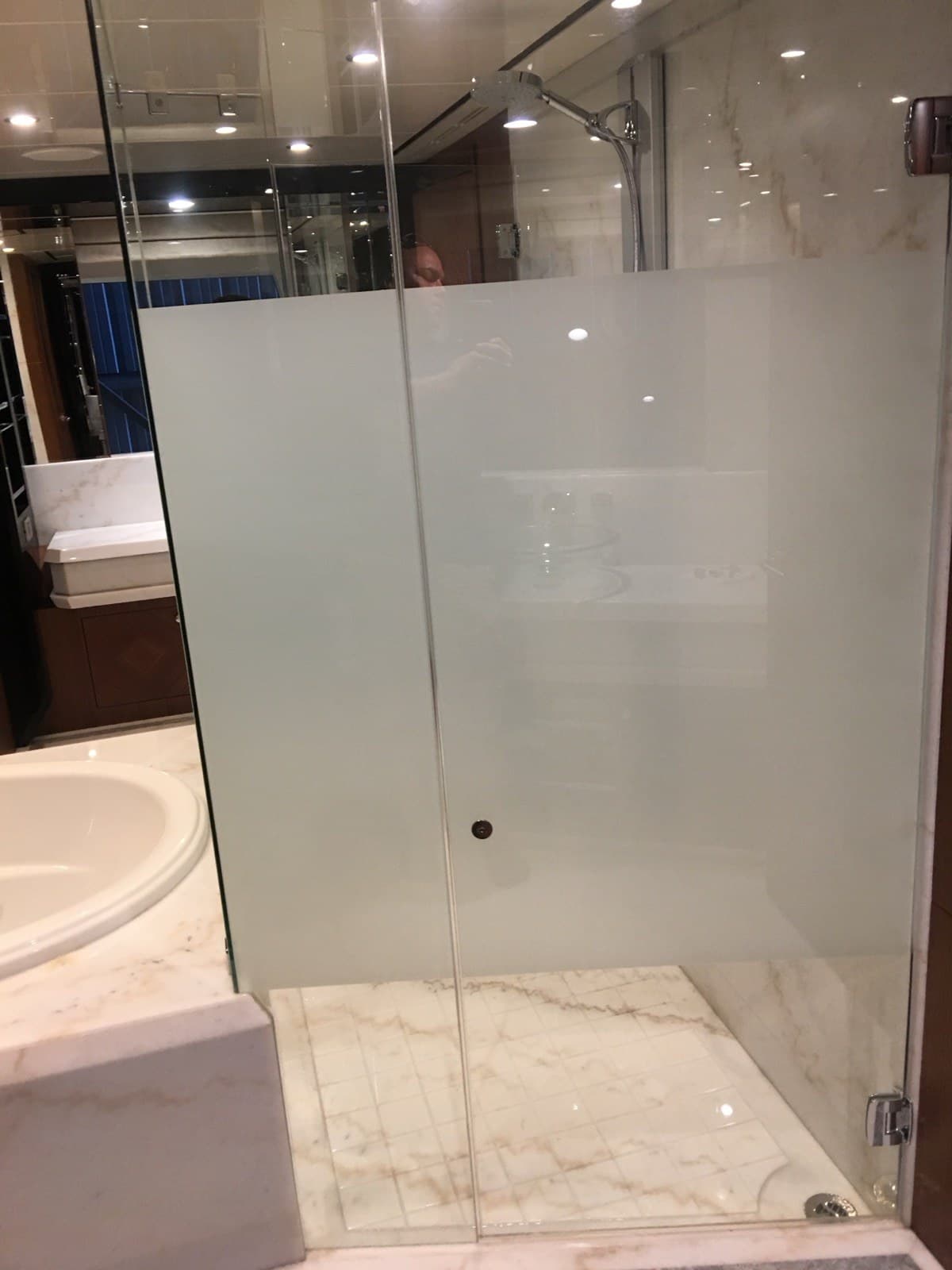 Frost privacy film on a yacht head shower door for nighttime cover